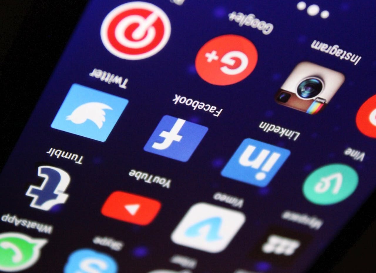 Crafting Captivating Headlines: Your awesome post title goes here Close-up of a smartphone screen showing various social media app icons such as Facebook and Twitter.